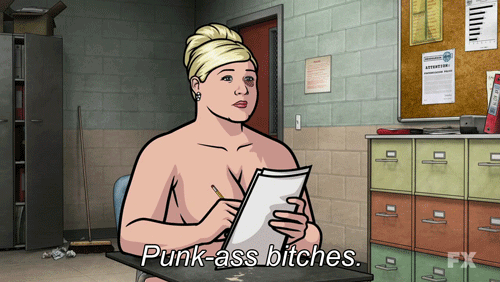 A GIF of Pam Poovey saying "Punk Ass Bitches" naked while writing on some papers.